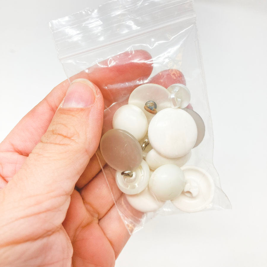 Small Bag of White Plastic Shank Buttons