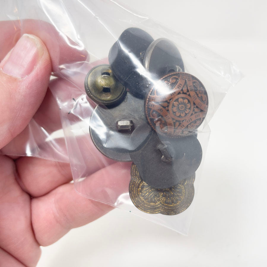 Copper, brass, and gold colored small bag of assorted shank buttons